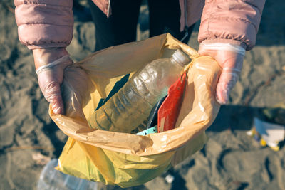 Low section of man holding fish