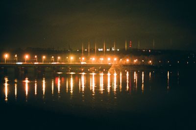 Illuminated city against sky at night