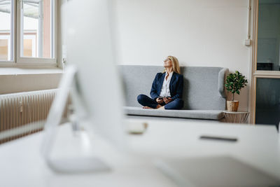 Relaxed businesswoman sitting on couch