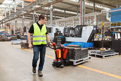 Rear view of man working in factory