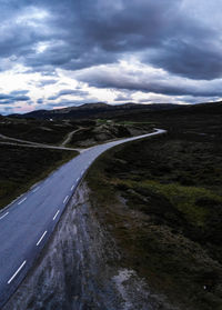 Scenic view of road by land against sky