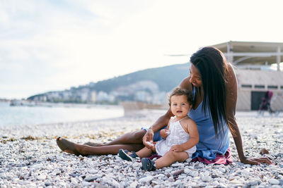 Mother and son on shore at beach