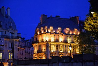 Illuminated cathedral against blue sky at night