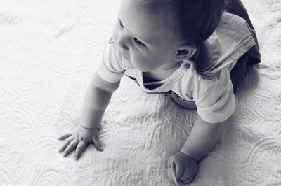 High angle view of baby girl on bed