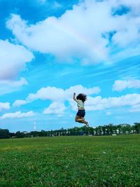 Boy on field against sky