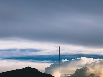 Low angle view of silhouette street against sky