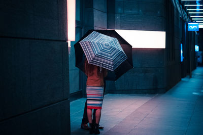 Rear view of man standing on tiled floor