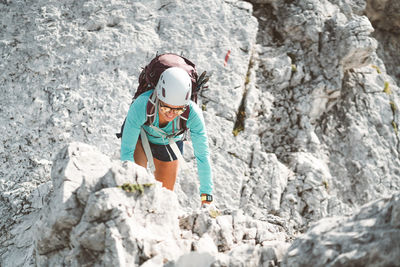 Rear view of woman standing on rock
