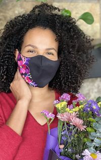 Portrait of beautiful woman with red flower