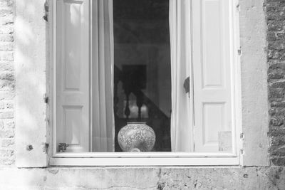 Urn on window sill