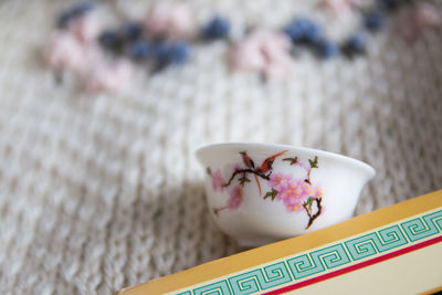 Top view of chinese tea cup arrangement with book