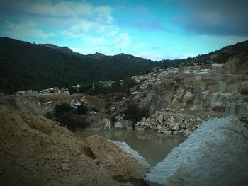 Scenic view of river amidst mountains against sky