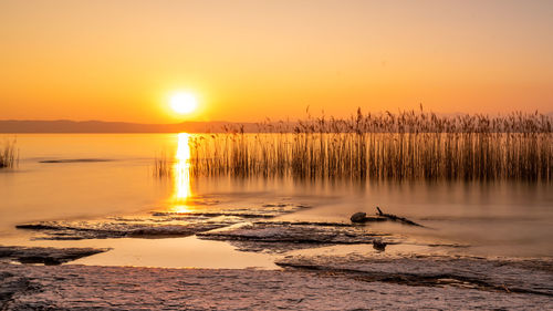 Scenic view of lake against sky during sunset