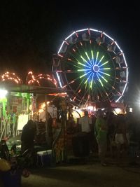 Illuminated ferris wheel at night