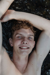 High angle portrait of smiling man lying down