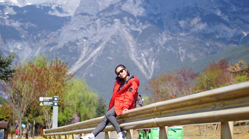 Portrait of woman against mountains during winter