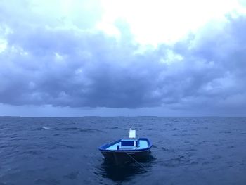 Boat moored on sea against sky