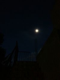 Low angle view of moon in the dark