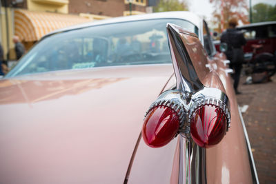 Close-up of red car on side-view mirror