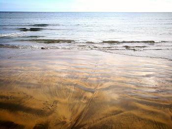 Scenic view of beach against sky during sunset