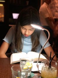 Woman with drink on table at restaurant