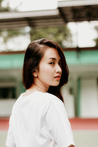 Portrait of beautiful young woman standing outdoors