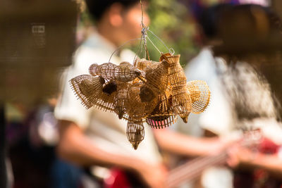 Close-up of basket making hanging outdoors