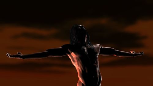 Rear view of shirtless man with arms outstretched