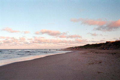 Scenic view of beach against sky during sunset