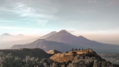 Scenic view of mountains against cloudy sky