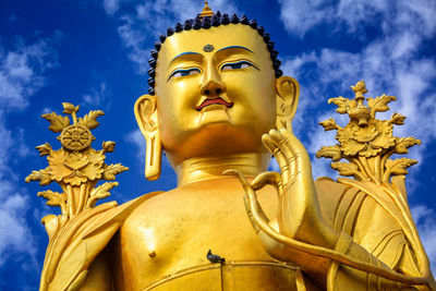 Low angle view of statue against sky