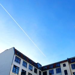 Low angle view of buildings against blue sky