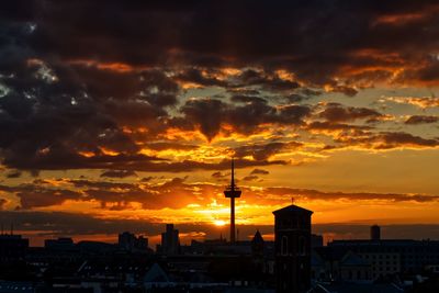 Buildings against cloudy sky during sunset