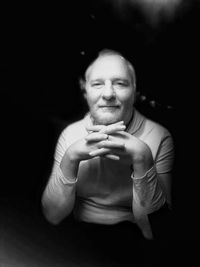 Portrait of mid adult man over black background