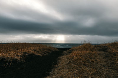 Scenic view of sea against storm clouds