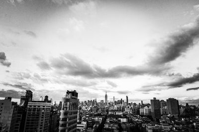 Cityscape against cloudy sky
