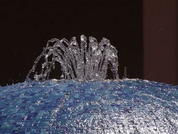 Close-up of water splashing against black background