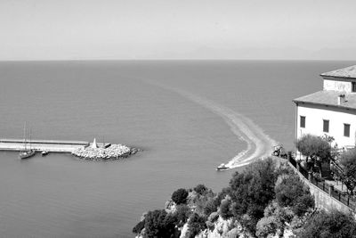 High angle view of buildings by sea against sky