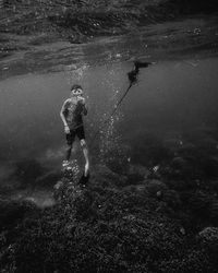 Full length of boy scuba diving undersea