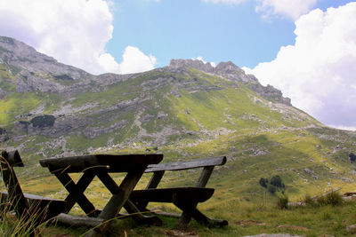 Country road in the mountains and resting bench in durmitor national park, montenegro