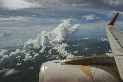 Aerial view of aircraft wing against sky