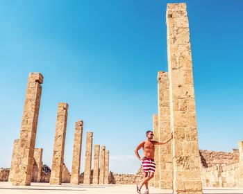 Young man leaning against column