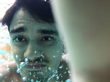 Underwater image of man swimming in pool