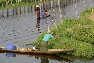 People rowing boats in lake