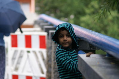 Portrait of boy standing on building terrace 