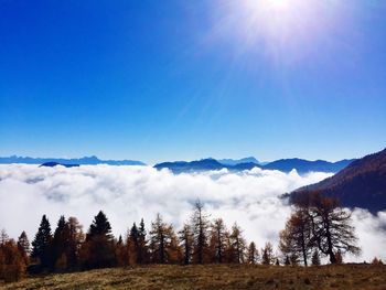 Scenic view of mountains against blue sky