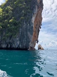 Scenic view of rock formation in sea against sky