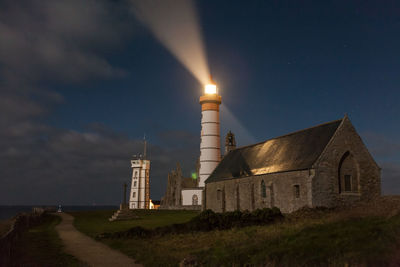 Lighthouse against sky at night