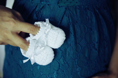 Close-up of woman hand holding white rose