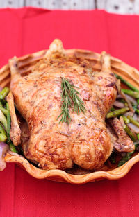 Close-up of roast chicken in container on table